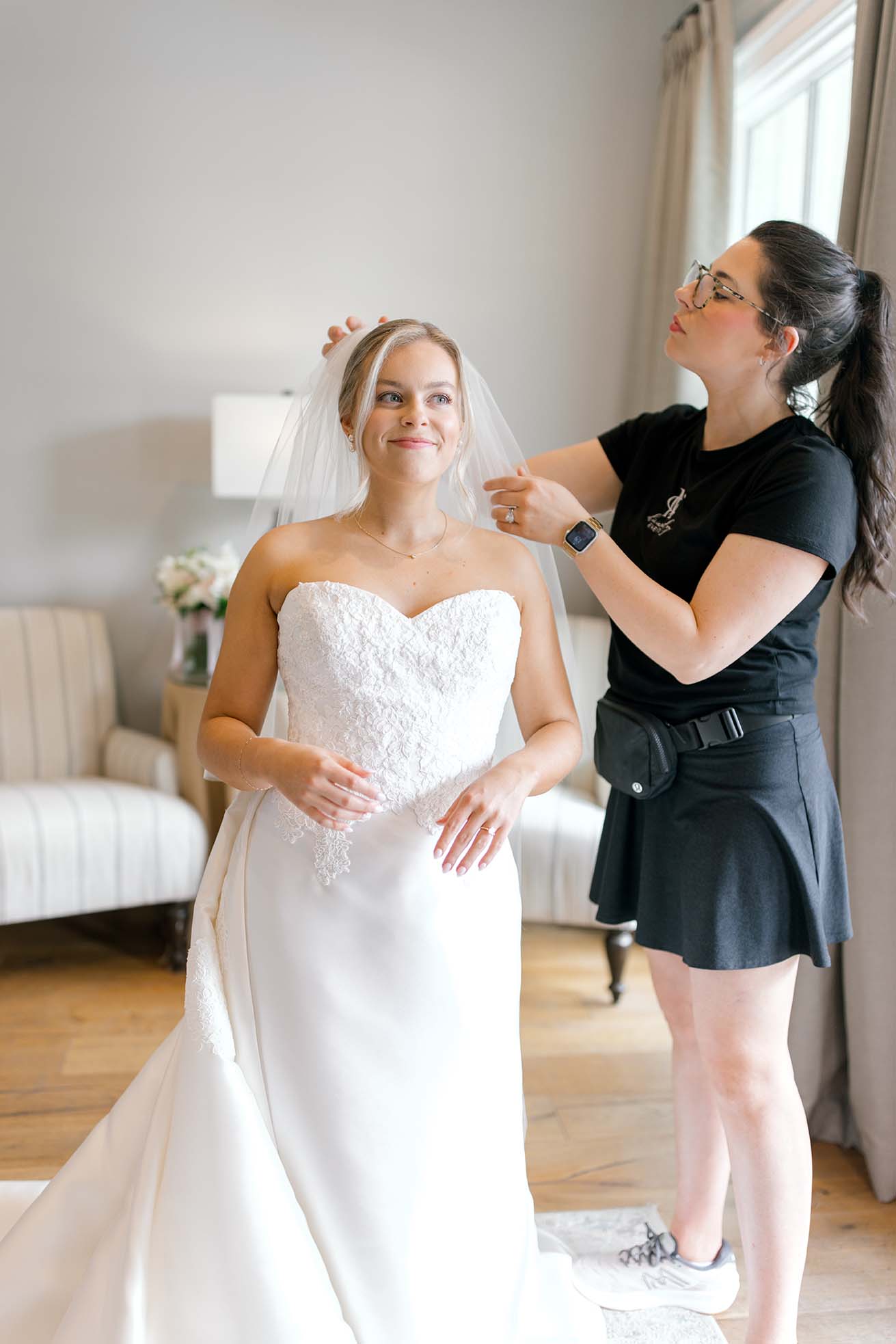 Olivia Miley helps a bride with her hair piece