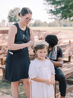 Olivia Miley helps flower girl with hair piece