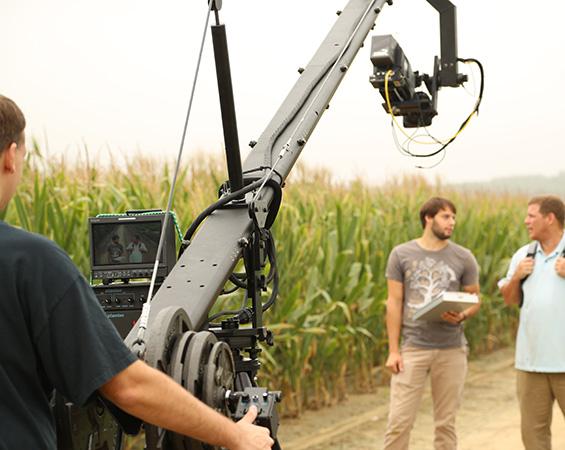 An interview being filmed next to a corn field