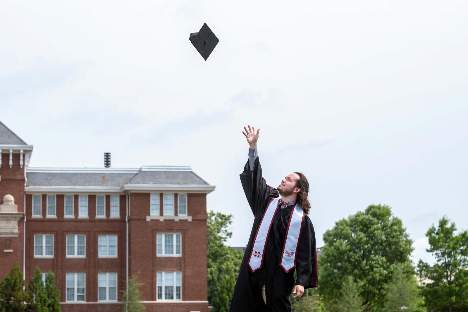 Graduate Mortar Board Toss on the Drill Field