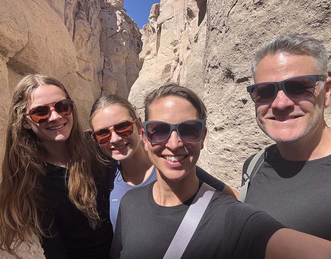 Lady Cox and her family smile at the camera in front of rock formations
